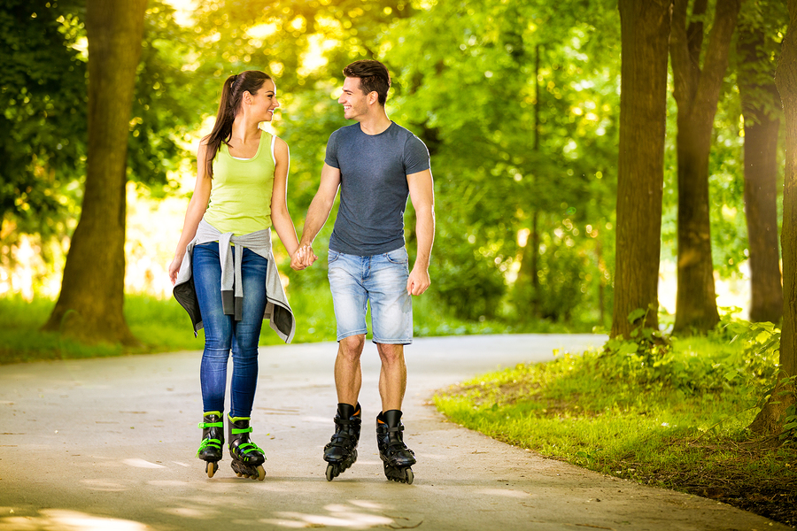 Young love couple spending free time  together, roller-skating i